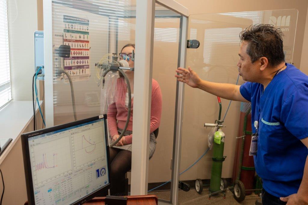 A female participating in a respiratory test. 